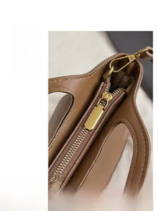 Close-up of golden hardware and premium stitching on a vintage brown leather bag