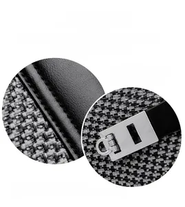 Close-up of polished silver buckle and precise stitching on black leather handbag