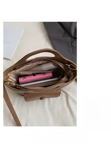 Interior view of brown leather bag showing spacious compartment with zipper pocket