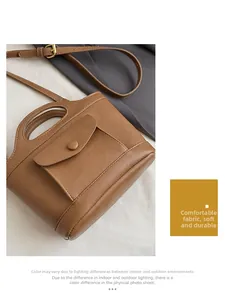 Detailed view of caramel leather handbag featuring adjustable strap and soft textured fabric