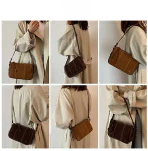Detail shots of brown matte faux suede crossbody bags with white contrast stitching