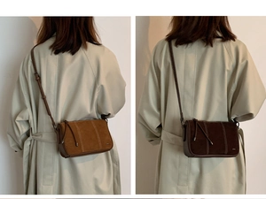 Detailed view of vintage crossbody bag in caramel and brown suede with visible stitching