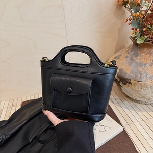 Minimalist black leather bucket bag with front pocket and gold hardware for women