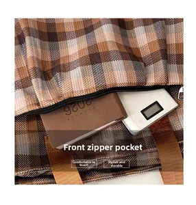 Macro detail of canvas tote bag front zipper pocket showing large storage capacity