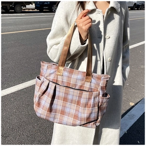 Detailed view of the checkered canvas tote bag with multi-pockets for daily storage