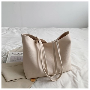 Minimalist beige tote bag in textured faux leather with large capacity for daily commuting