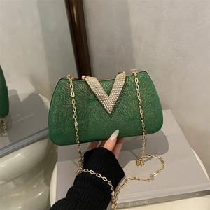 Elegant green rhinestone clutch with gold V-shape buckle and metallic chain strap
