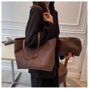 Detail of dark brown lychee leather tote bag set including matching small zippered pouch