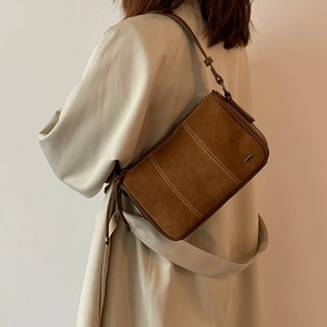 Brown vintage suede shoulder bag with white stitching detail and minimalist rectangular shape