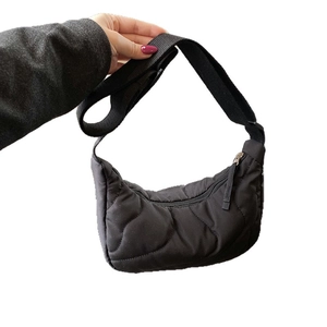Chic black wave-quilted shoulder bag with wide strap in casual nylon slouchy style