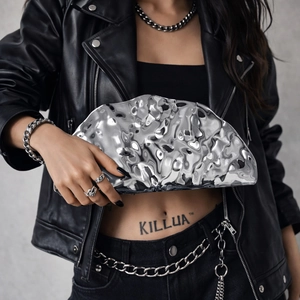 Silver liquid metal acrylic clutch with wavy texture and chain strap for evening events