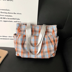 Large checkered canvas tote bag with side pockets and durable wide shoulder straps