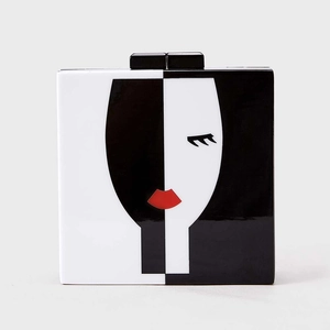 Detail of artistic acrylic evening bag with abstract face silhouette and glossy finish