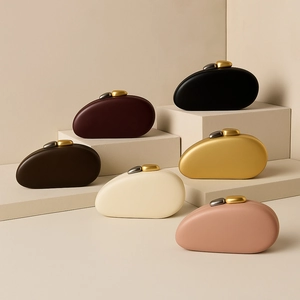Collection of pebble-shaped evening clutch bags in six colors with metallic stone clasps