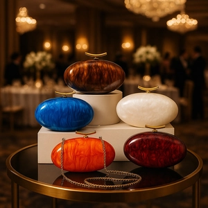 Detailed view of acrylic evening bags with marble patterns and gold crescent clasps