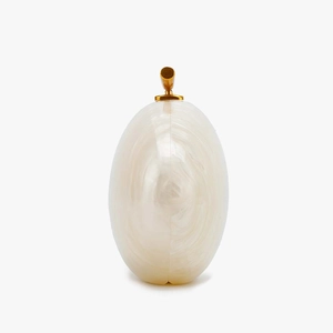 Detail of white marble texture acrylic clutch bag with a sleek gold cylindrical metal clasp