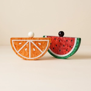 Detailed view of acrylic evening bags shaped like orange and watermelon fruit slices
