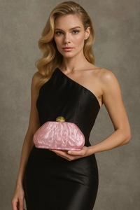 Pink marble shell acrylic clutch bag with golden spherical clasp held by a model