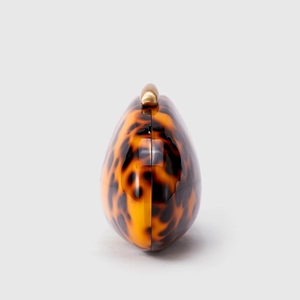 Acrylic evening clutch with tortoiseshell pattern and gold metal clasp in shell shape