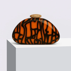 Modern orange acrylic shell clutch bag with abstract black lines and gold clasp