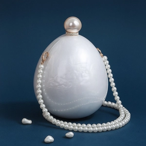 Elegant pearl-shaped acrylic evening clutch with large pearl clasp and bead strap
