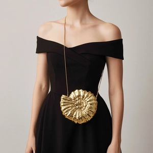Elegant gold shell-shaped evening clutch bag with metallic texture and chain strap