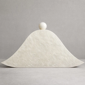 Detailed macro view of white marble acrylic evening bag with spherical clasp