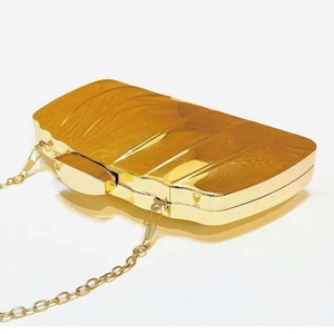 Elegant amber acrylic clutch bag with gold metal frame and chain for evening parties