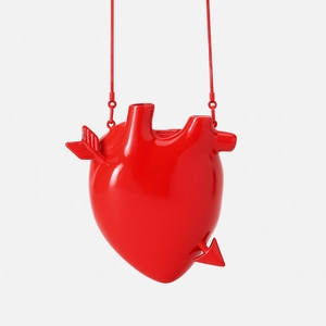 Makro-Detail der roten 3D-Handtasche in Herzform mit Glanzeffekt und roter Kette