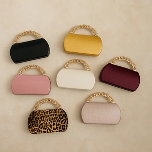 Flat lay of colorful PU evening clutch bags with chunky gold chain handles
