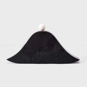 Acrylic black marble shell clutch bag with a white spherical clasp for evening events