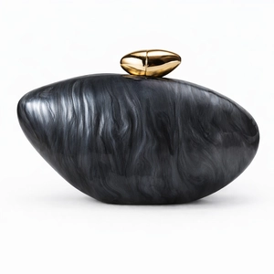 Detail of marble pattern acrylic clutch bag with artistic gold oval metal lock