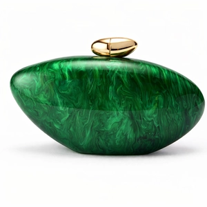 Detail shot of luxury green marble acrylic clutch with elegant golden metal teardrop clasp