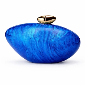 Detailed close-up of a blue marble texture acrylic evening clutch with gold metal clasp