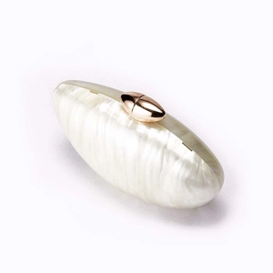 Detail of pearlescent shell texture acrylic evening clutch with rose gold clasp