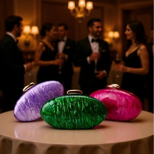 Detailed macro of acrylic evening shell clutch bags with marble textures and gold metal clasps