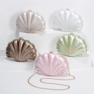 Shell-shaped acrylic evening clutches in five pearlescent colors with gold chain straps