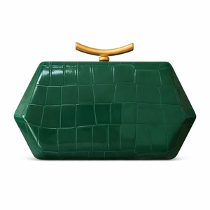 Detail view of dark green crocodile texture handbag with gold crescent handle