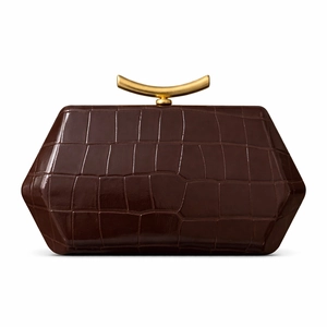 Detail of dark brown crocodile-embossed bag with unique geometric shape and gold handle