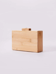 Detail showing natural bamboo texture and wooden clasp on the rectangular handmade bag