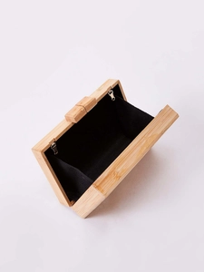 Inside view of rectangular bamboo clutch bag with black lining and zipper pocket
