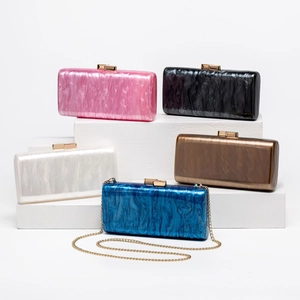 Detailed display of acrylic shell evening clutch bags in various marble textured colors
