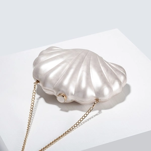 Chic shell-shaped acrylic evening clutch with pearl finish and gold chain shoulder strap