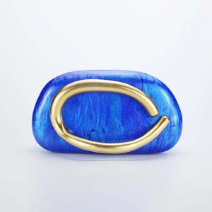 Macro detail of blue resin shell clutch with wavy textures and golden metal trim