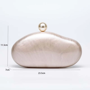Detailed size view of acrylic shell clutch bag with pearl clasp and marble texture