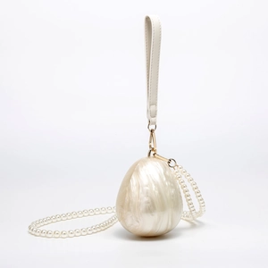 Pearlescent white shell acrylic clutch with marble texture, pearl chain, and gold accents