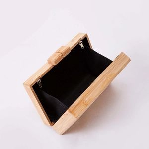 Handmade rectangular bamboo box clutch bag with natural wood grain and black fabric lining