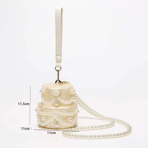 Detail of cake-shaped acrylic clutch with marble texture, pearls, and sizing labels