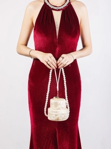 Exquisite pearl cake-shaped clutch bag held by model in red dress for evening wedding