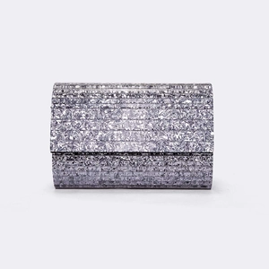 Detailed view of silver striped acrylic clutch bag with metallic foil texture and layering